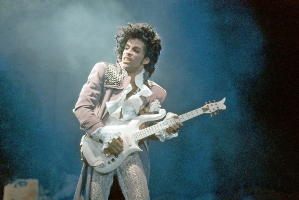 Prince playing his custom white cloud guitar in the film Purple rain