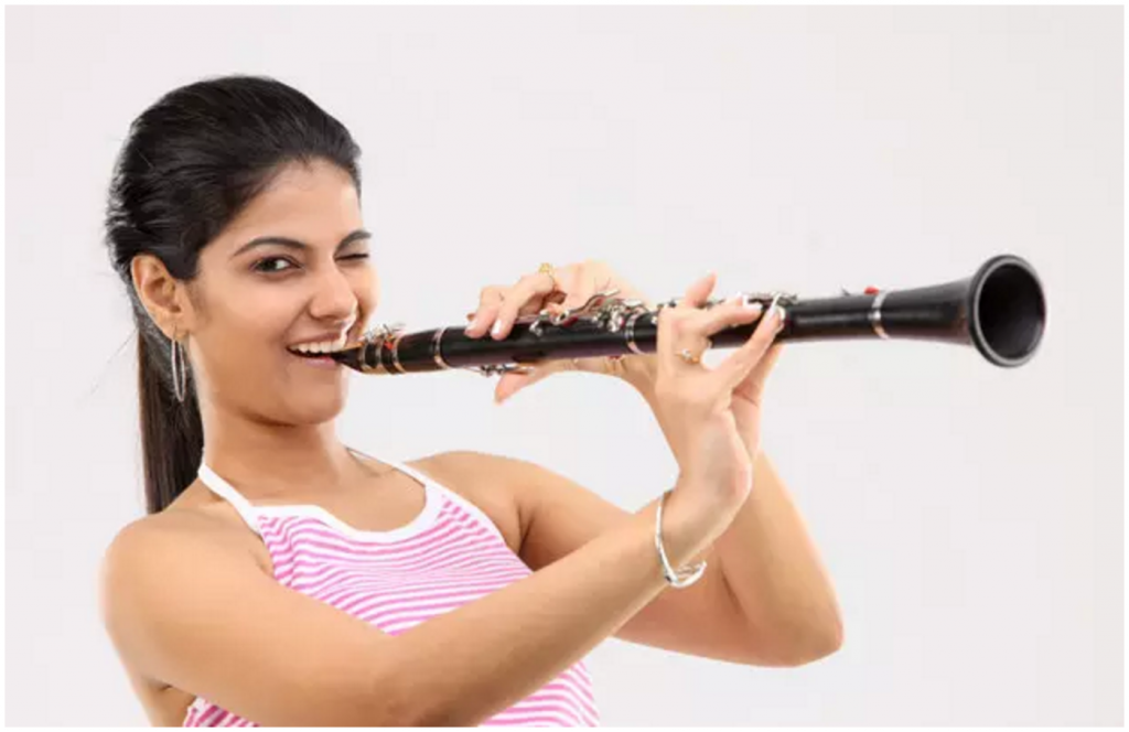 Girl playing a clarinet and winking