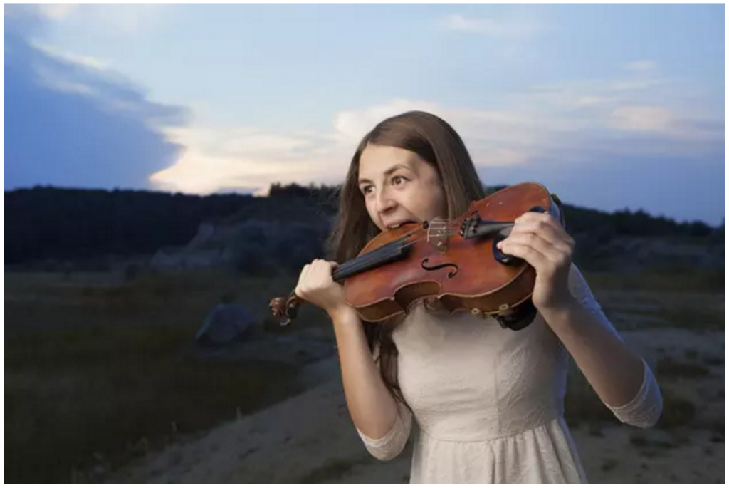 Girl biting a violin