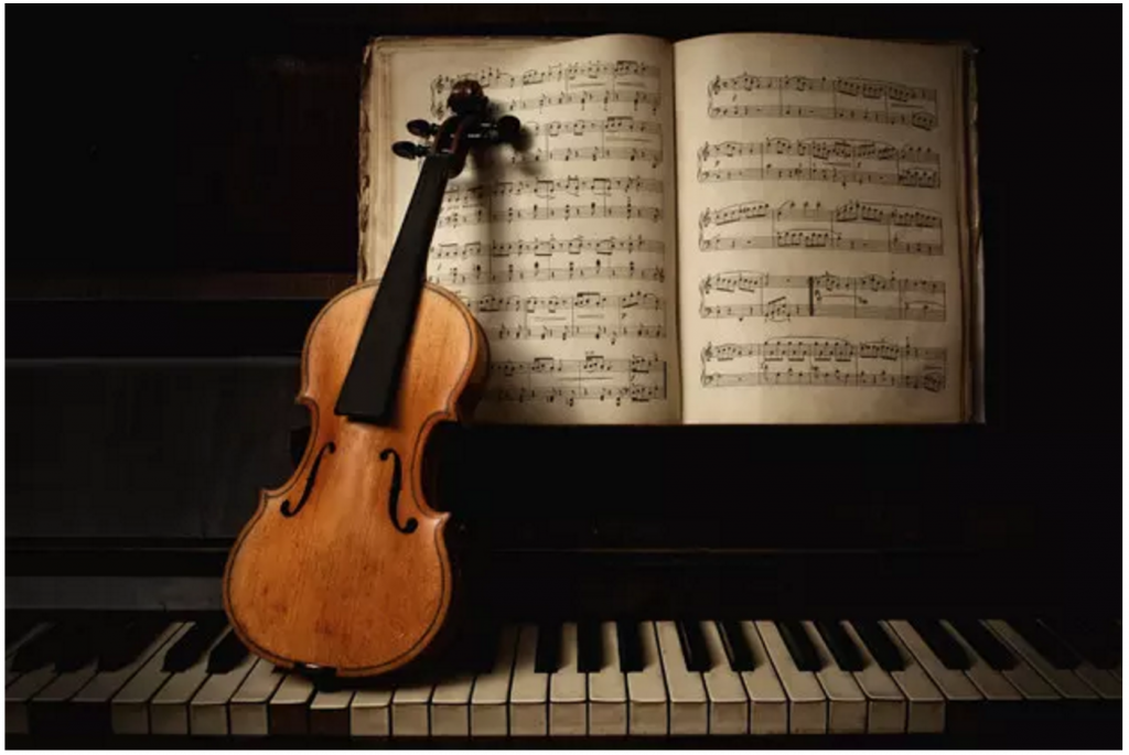 Violin without strings on a piano