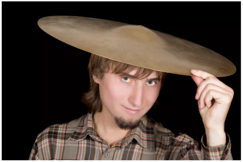 Man with cymbal on his head