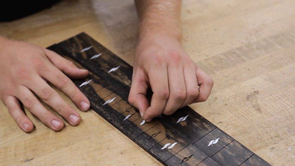 Inserting fretboard inlays by hand