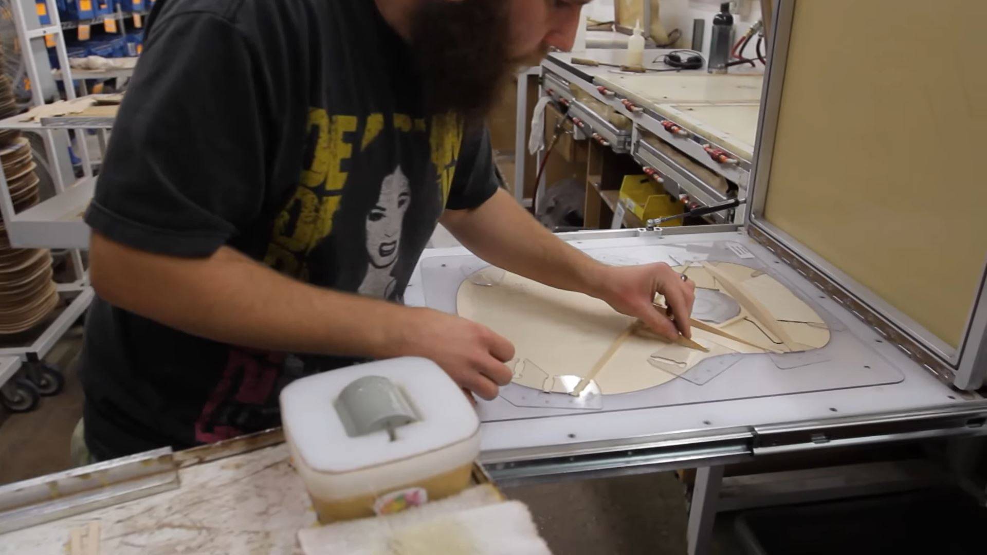 Taylor employee adding extra bracing to the guitar top