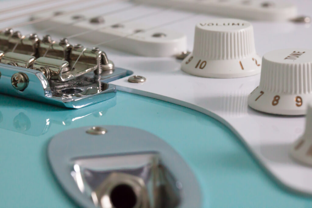 A Fender Stratocaster's control knobs and bridge.