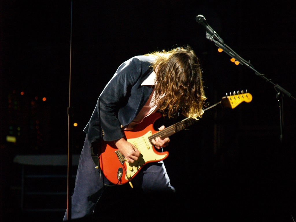 Red Hot Chilli Peppers guitarist John Frusciante performing live with a red Fender Stratocaster.
