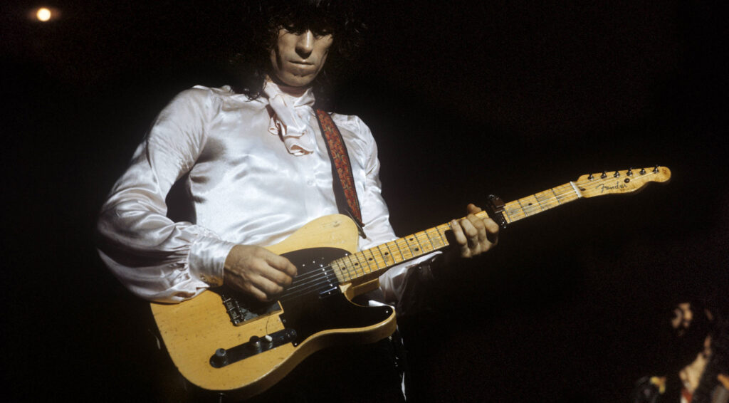 Live photo of Rolling Stones guitarist Keith Richards holding his "Micawber" Telecaster.